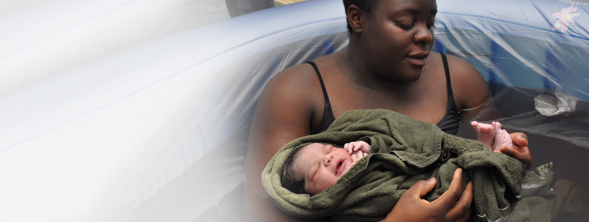Woman with baby in birthing tub